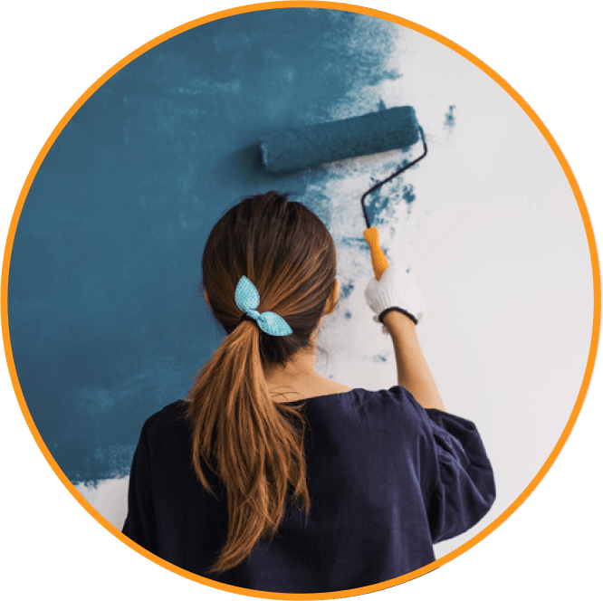 girl painting wall with blue paint@2x